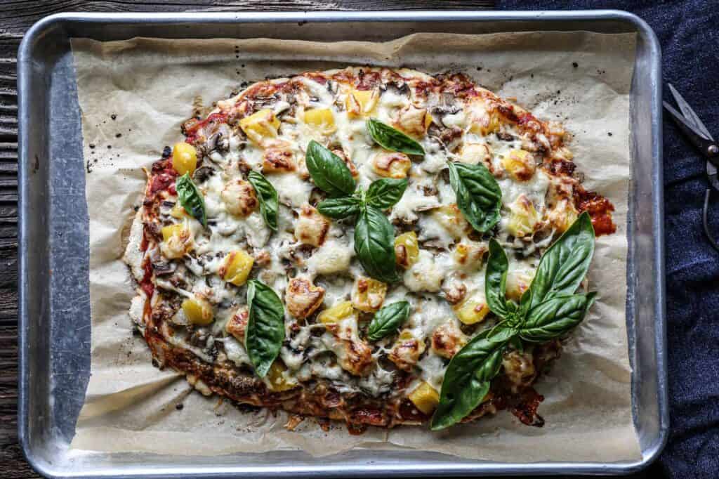 gluten free sourdough pizza crust with sausage, mushrooms, pinapple and lots of cheese