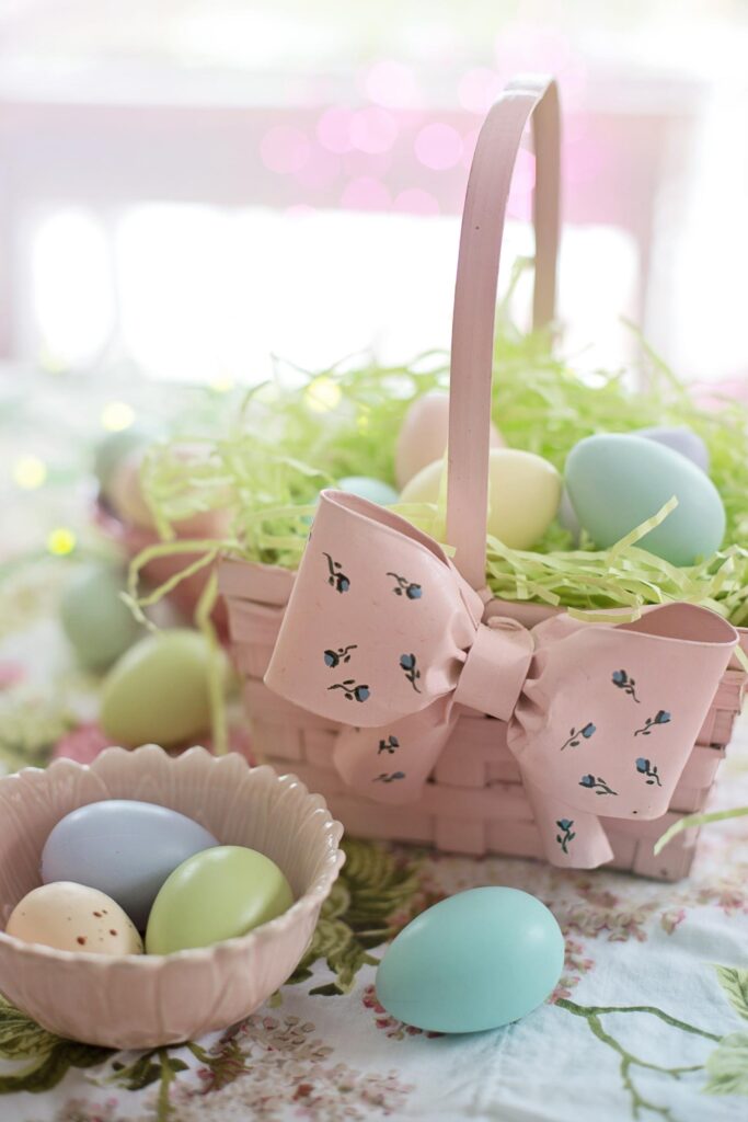 a pink basket idea with green faux grass filling and various colored Easter eggs filled with gluten free Easter candy.